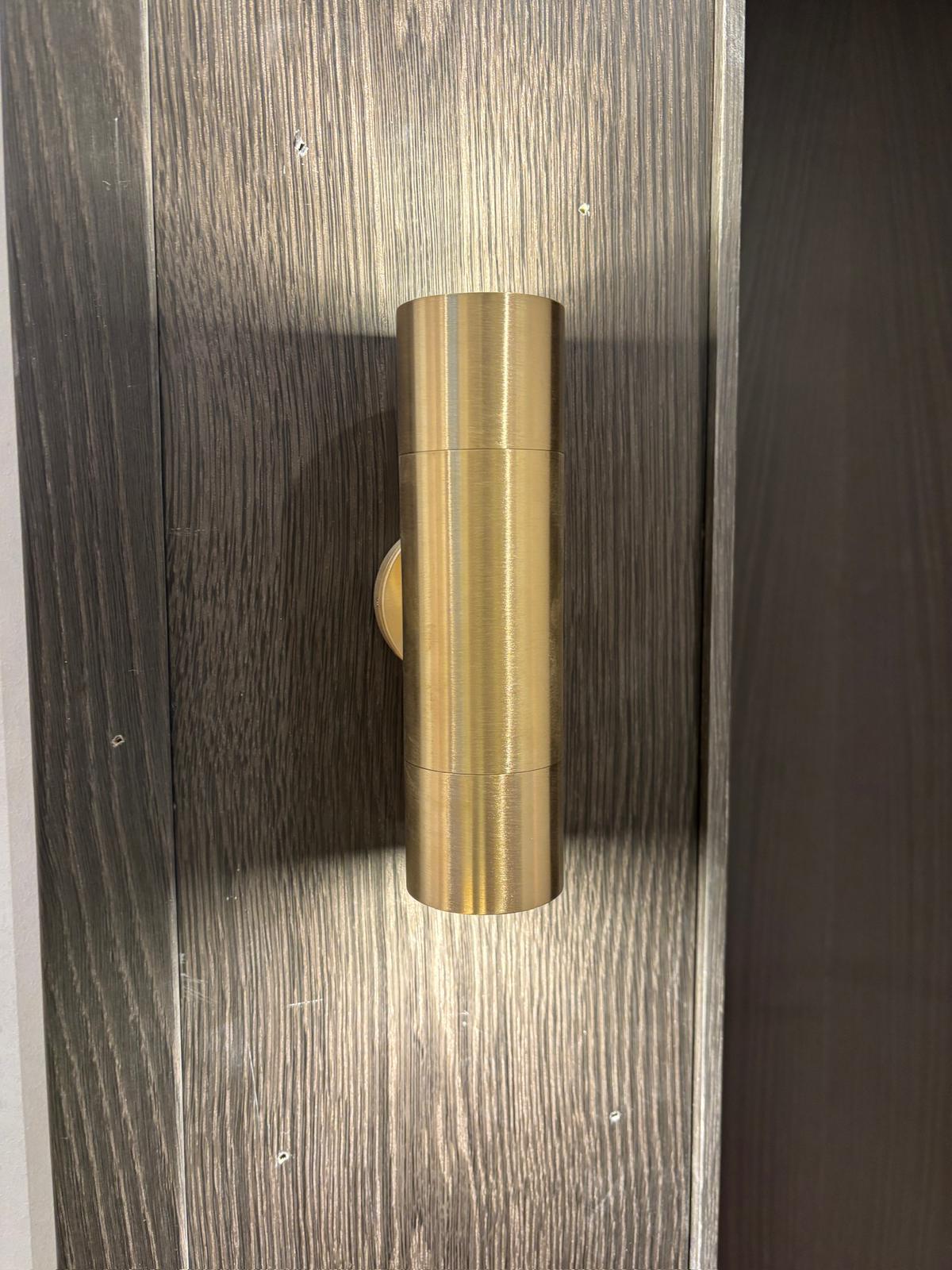 Decorative wall light installed on wood panel feature wall